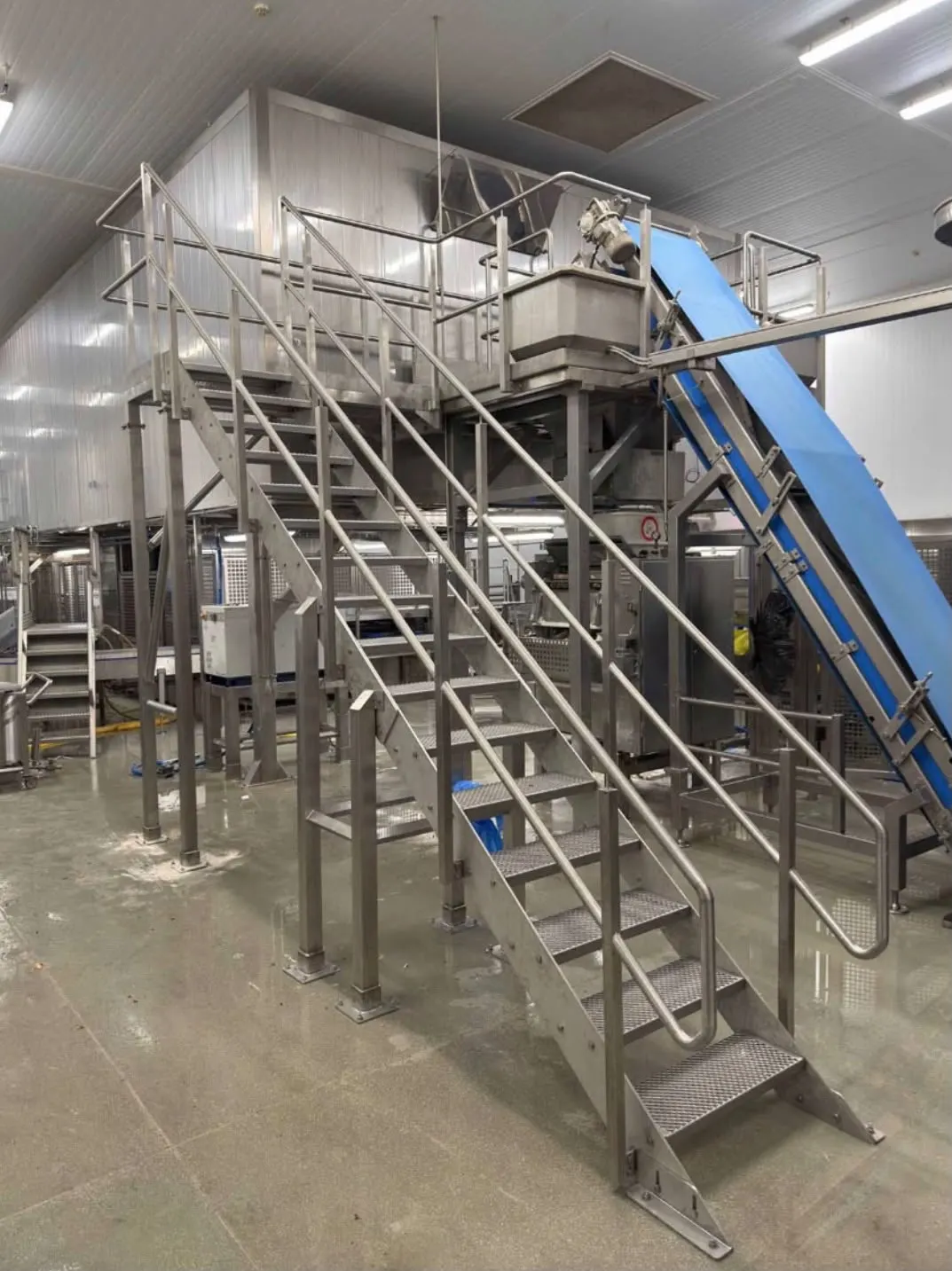 Bespoke stainless steel mezzanine access platform, staircase and conveyor installed in a food factory